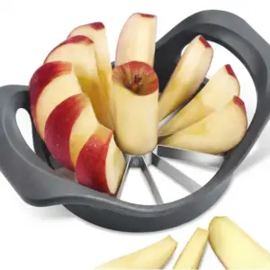 Black apple slicer holding a red apple cut into eight wedges, with more wedges beside it on a white surface
