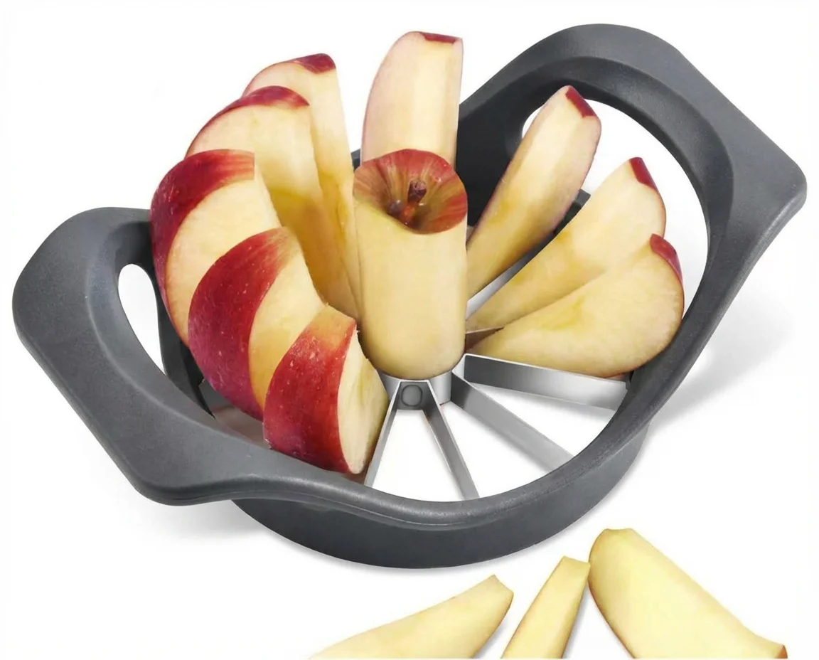 Black apple slicer holding a red apple cut into eight wedges, with more wedges beside it on a white surface