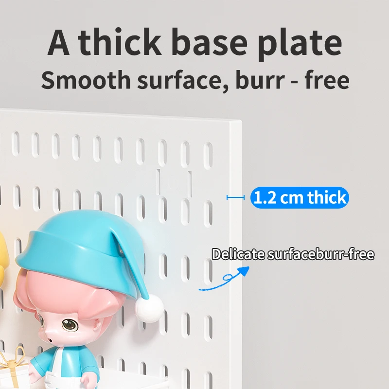 Edge-on view of the white pegboard panel with a 1.2 cm thickness callout, showing its smooth slotted face and a figurine