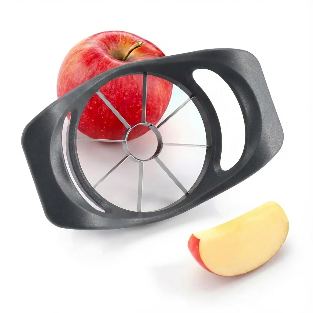 Black apple slicer resting on top of a whole red apple, with one cut apple wedge lying beside it
