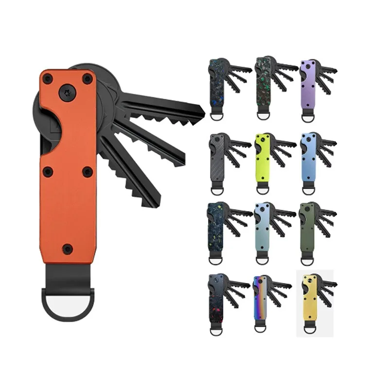 Orange folding key organizer with four black keys fanned out, beside a grid of twelve other colourways