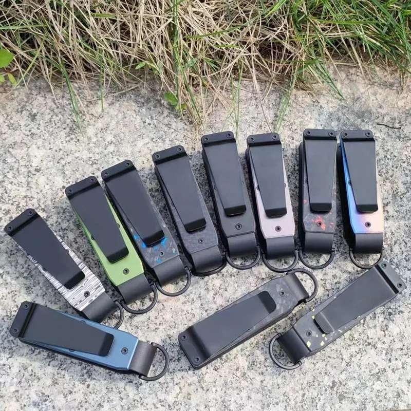 Key organizers face down on stone, showing the black back clip and the D-ring loop at the base of each one
