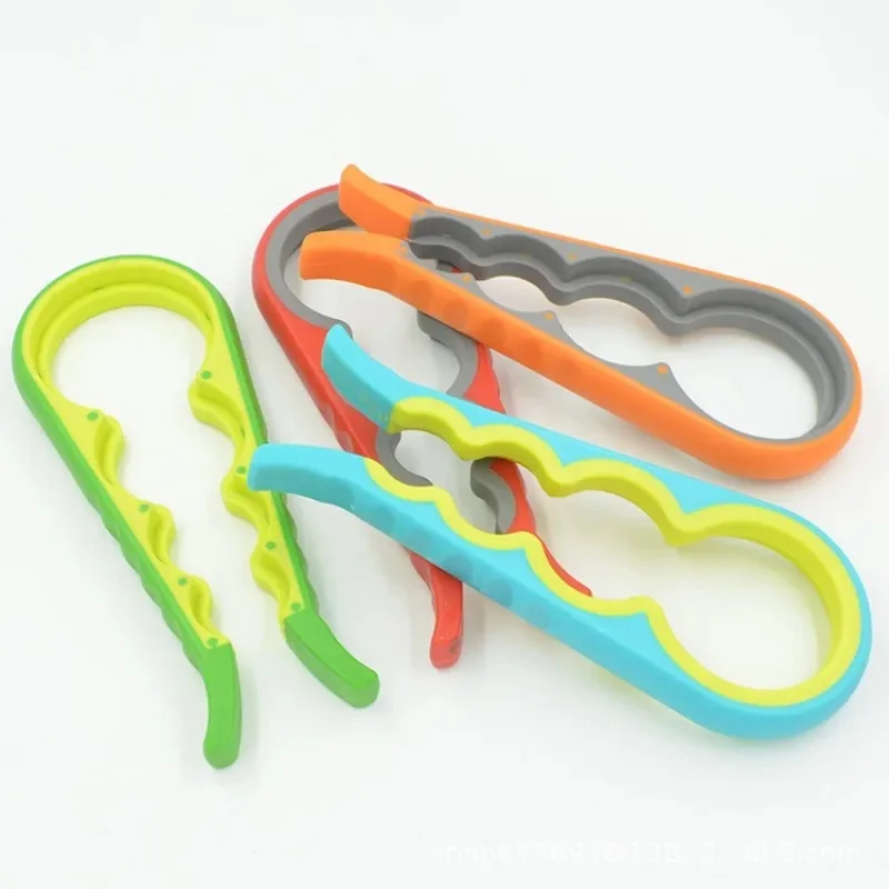 Four 4-in-1 jar openers in green, blue, orange and red laid out on a white surface