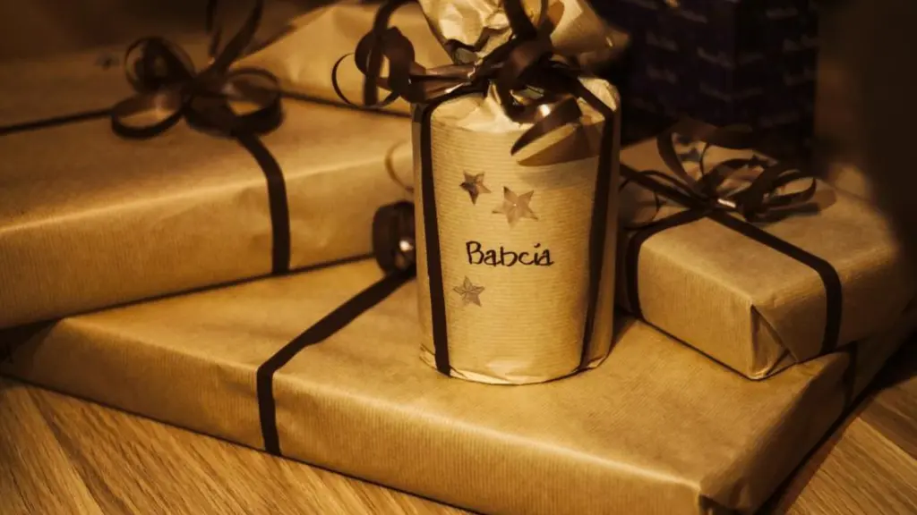 Two parcels wrapped in brown kraft paper and tied with black ribbon, one carrying a gold star tag.